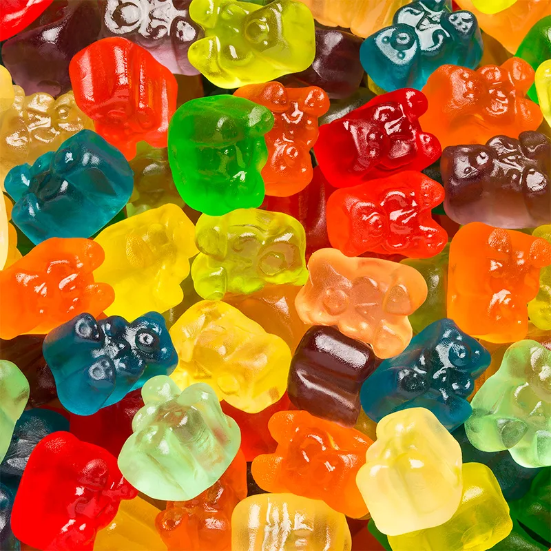 Assorted colorful gummi bears in various flavors displayed closely together, ideal for wholesale candy suppliers and food distributors.